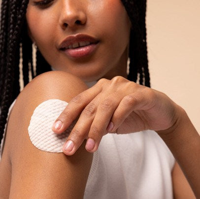 Woman using a pad on her upper arm